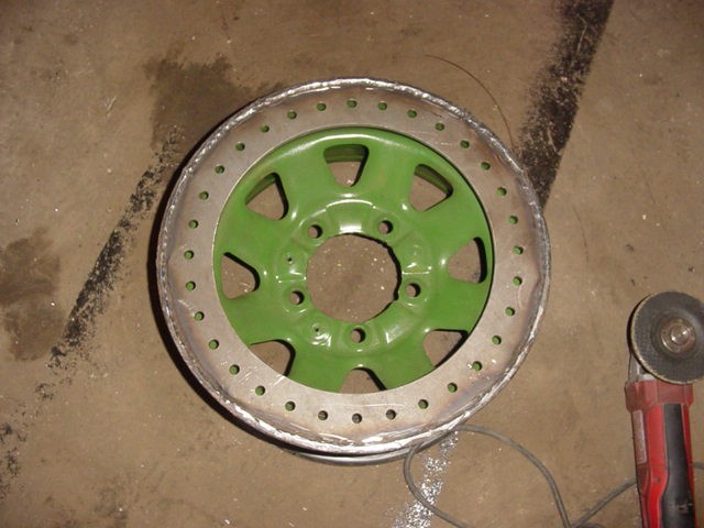 Green wheel with custom beadlock ring, next to an angle grinder