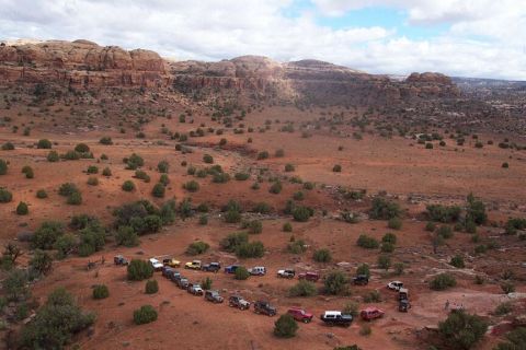 1990 Ford Bronco - Moab 4/04 - the rigs as viewed from the hike to the Arch