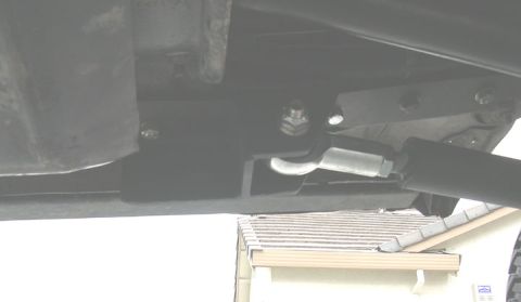 1994 Ford Bronco - Close-up view of an underbody suspension component, showing a bracket and bolt assembly.