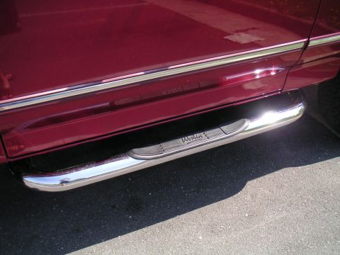1994 Ford Bronco - Close-up of Westin step bars on a vehicle's lower body panel.