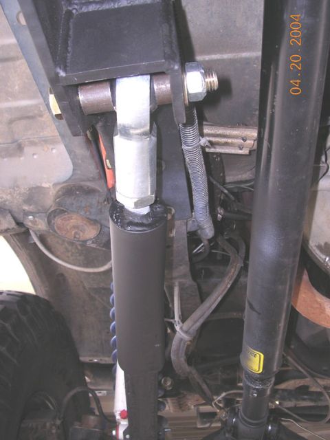1994 Ford Bronco - Close-up view of the suspension system's shock absorber and related components.