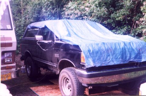 1987 Ford Bronco - It's not as bad as it looks, the tranny went out, and due to our lovely coastal weather, we decided to tarp it while we pulled it out.