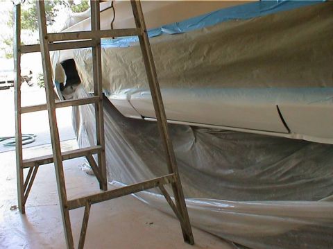 1979 Ford Bronco - A vehicle is being prepped for painting, with a ladder positioned nearby and the body covered in protective materials.