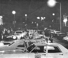 1995 Ford Crown Victoria - A busy street scene at night with many cars, some appearing to be police vehicles.