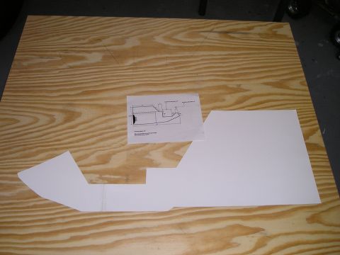 1996 Ford Bronco - Paper templates and a diagram are arranged on a wooden surface, likely for a custom car part project.