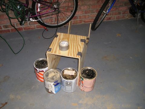 1996 Ford Bronco - Wooden console project with paint cans and tape, possibly for a vehicle interior.