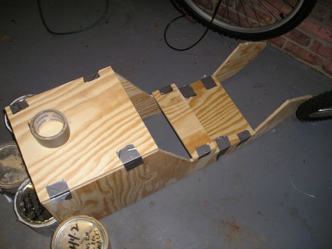 1996 Ford Bronco - A custom wooden frame is under construction, held together with duct tape and resting on the floor.