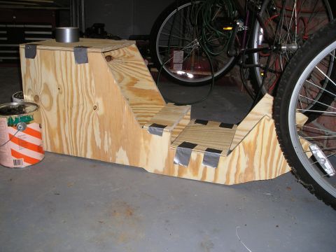 1996 Ford Bronco - A custom-built wooden console structure is shown, partially obscured by bicycle wheels and next to a paint can.