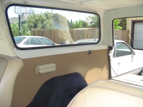 1979 Ford Bronco - View from inside a 1979 Ford Bronco, looking out at a white car parked in a driveway.