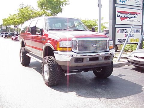 2001 Ford Excursion - Front view of a red 2001 Ford Excursion with a lifted suspension and large off-road tires.