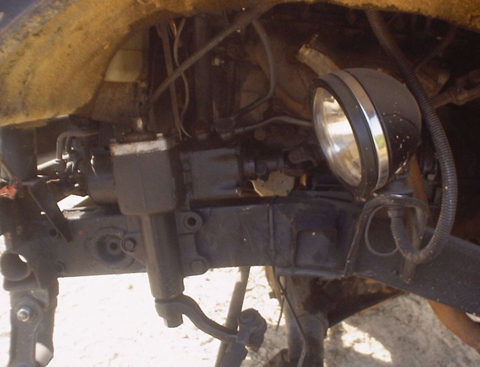 Undercarriage of a vehicle with a spotlight attached to the frame