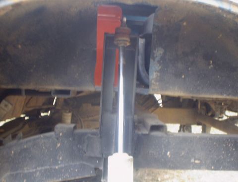 1989 Ford Bronco - Close-up view of the rear suspension system, showing shock absorber and mounting hardware.