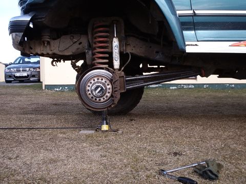 1996 Ford Bronco - Repairing the rear suspension on a 1996 Ford Bronco, with a second vehicle in the background.