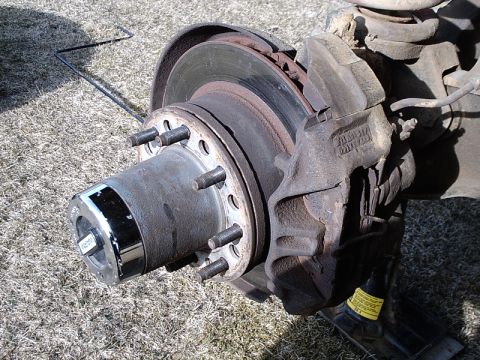 1996 Ford Bronco - The brake system of a vehicle is shown, with a focus on the rotor and caliper assembly.