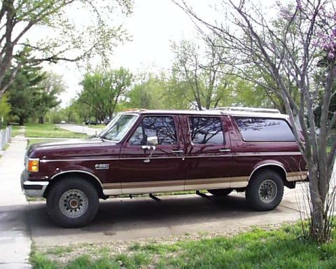 1988 Ford C-350 (Centurion Conversions) - This maroon extended cab pickup truck features a camper shell and appears to be a 1988 Ford F-250, possibly a Centurion conversion.