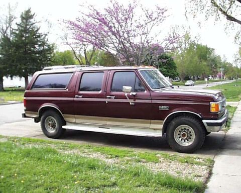 1988 Ford C-350 (Centurion Conversions) - Side view of a maroon Ford F-Series SUV conversion, likely from the late 1980s.