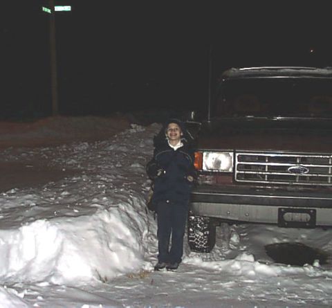 1988 Ford C-350 (Centurion Conversions) - A person stands in front of a 1988 Ford C-350 (Centurion Conversions) truck during a snowy night.