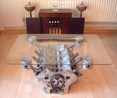 1985 Ford F-150 - A V8 engine block serves as the base for a glass-topped coffee table.