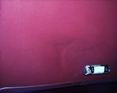 1988 Ford C-350 (Centurion Conversions) - A dent is visible on the side of a vehicle, near a chrome light fixture.