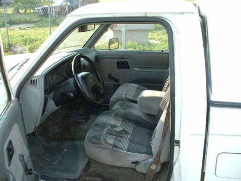 1992 Ford Ranger - The interior of a 1992 Ford Ranger pickup truck is shown, cloth seats and a manual transmission.