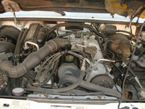 1992 Ford Ranger - Engine bay view of a 1992 Ford Ranger, showing the V6 engine and associated components.
