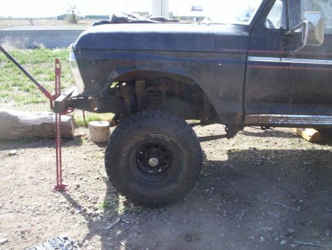 1978 Ford Bronco - 1978 Ford Bronco front fender and tire with a Hi-Lift jack attached.