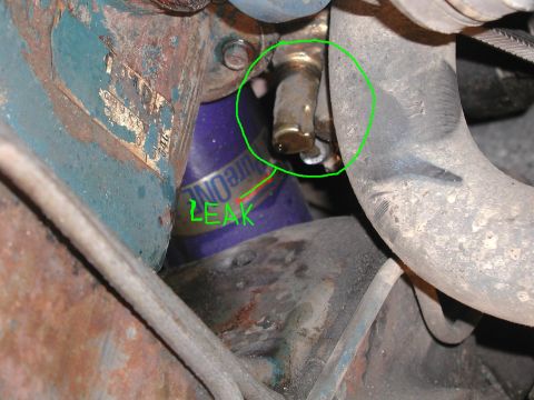 1985 Ford Bronco - A close-up view of an engine component showing a leak, marked with a green circle and text.