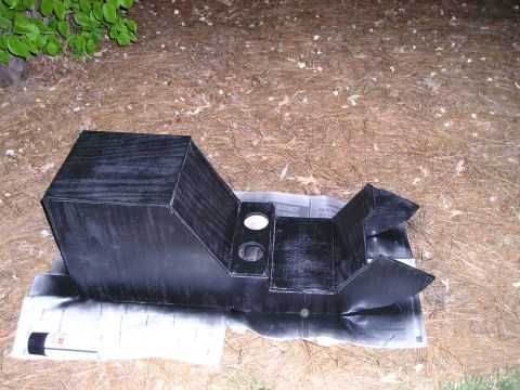 1996 Ford Bronco - A custom-made black center console with integrated cup holders is shown outdoors, resting on newspaper.