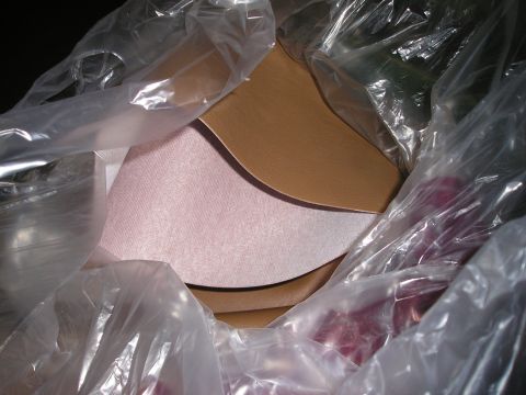 1996 Ford Bronco - Several pieces of material, possibly for a custom center console, are wrapped in plastic packaging.