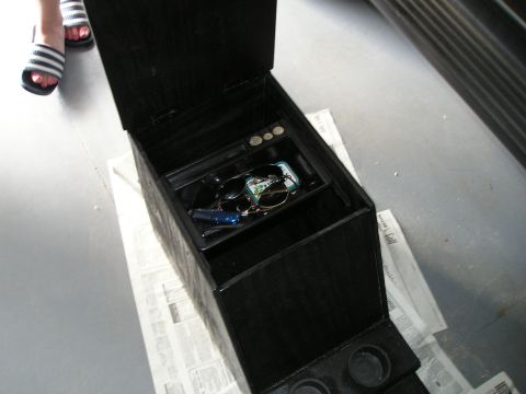 1996 Ford Bronco - A custom center console is shown open, containing personal items like sunglasses and keys.