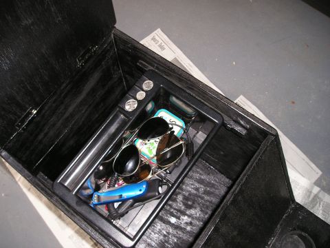 1996 Ford Bronco - Interior view of a custom center console, holding sunglasses, coins, and a utility knife.
