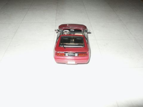 1998 Mercury Sable - Rear view of a red coupe model car on a tiled surface.