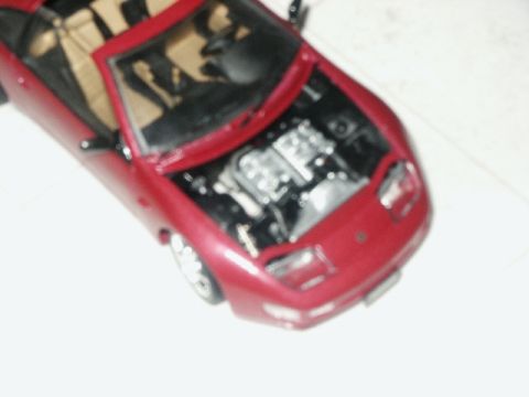 1998 Mercury Sable - This red convertible model shows its engine with the hood open.