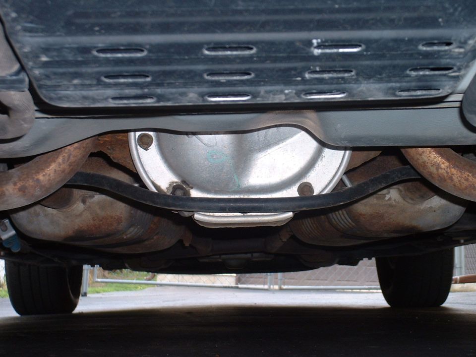 Undercarriage view of a vehicle's rear differential and dual exhaust pipes