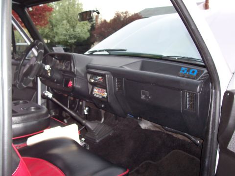 1990 Ford Bronco - Interior view of a 1990 Ford Bronco, showing the dashboard, steering wheel, and roll cage.