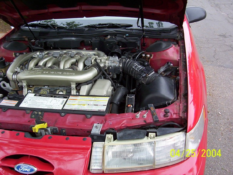 Red 1995 Ford Taurus engine bay with V6 engine