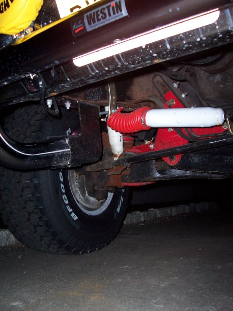 1990 Ford Bronco - Close-up of a vehicle's undercarriage, focusing on suspension and tire details.