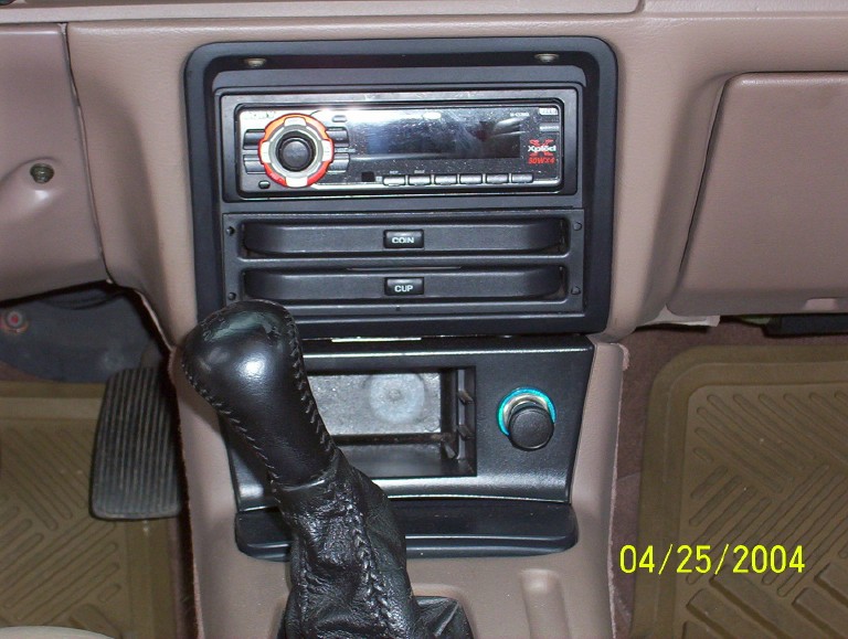 Car interior with gear shifter, car stereo, and date stamp 04/25/2004