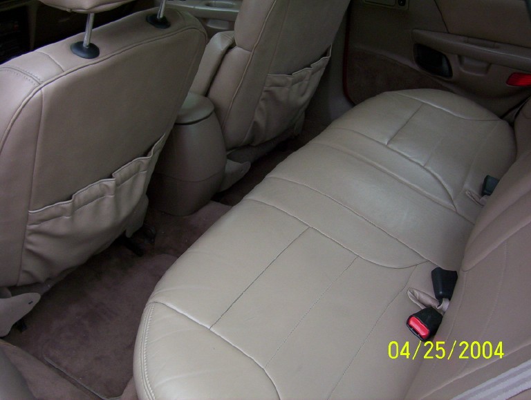 Interior view of car seats and floor mats. Date stamp reads 04/25/2004