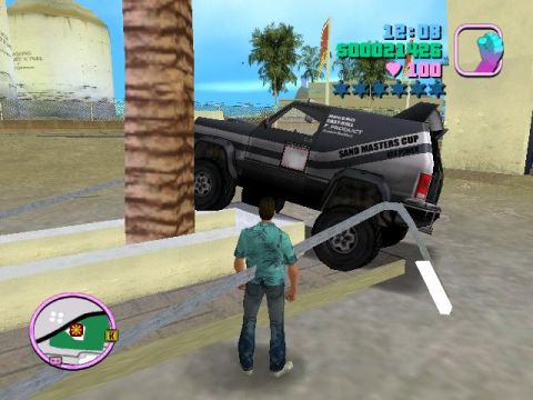 1988 Ford Bronco - A man stands near an off-road vehicle with racing decals, positioned on a raised surface.
