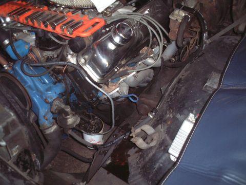 1967 Ford Galaxie - The engine bay of a 1967 Ford Galaxie shows a blue engine block and chrome valve covers, with a socket organizer visible.