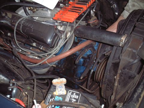 1967 Ford Galaxie - Close-up view of an engine bay chrome valve covers and an orange socket organizer mounted above.