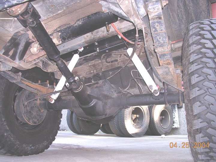 this is mounted up in there, painted, and flexed as in the following pics.  the stuffed tire is hitting the body, so i will have to bumpstop it there, and the extended side still has another 7.5 inches of stroke left in the shock.  I think I have way more than enuf shock now.