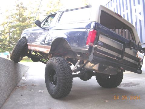 1994 Ford Bronco - again, all tires firmly on the ground and no where near lift. the front tire is about 36" off the ground, but the rears are ramped down, so…