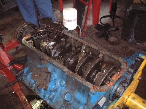 1967 Ford Galaxie - Engine block with crankshaft and connecting rods visible, undergoing maintenance.