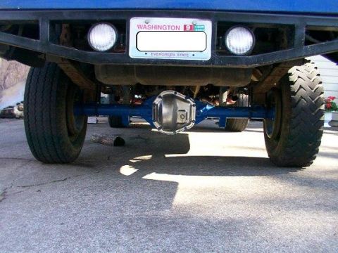 1980 Ford Bronco - The underside of a vehicle is shown, focusing on the rear axle and bumper assembly.