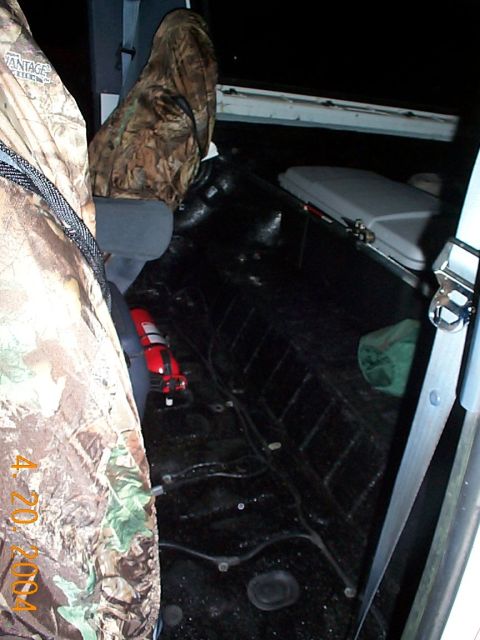 1992 Ford Bronco - Vehicle interior with camouflage seat covers and a fire extinguisher visible on the floor.