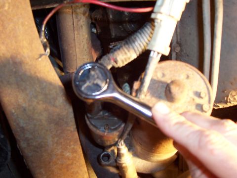 1994 Ford Bronco - A wrench is used to service the starter motor, a component often found in vehicles.