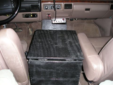 1996 Ford Bronco - The vehicle's interior features a custom-built wooden center console with a CB radio installed above it.