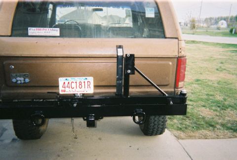 1983 Ford Bronco - Aftermarket rear bumper and spare tire mount installed on a vehicle.